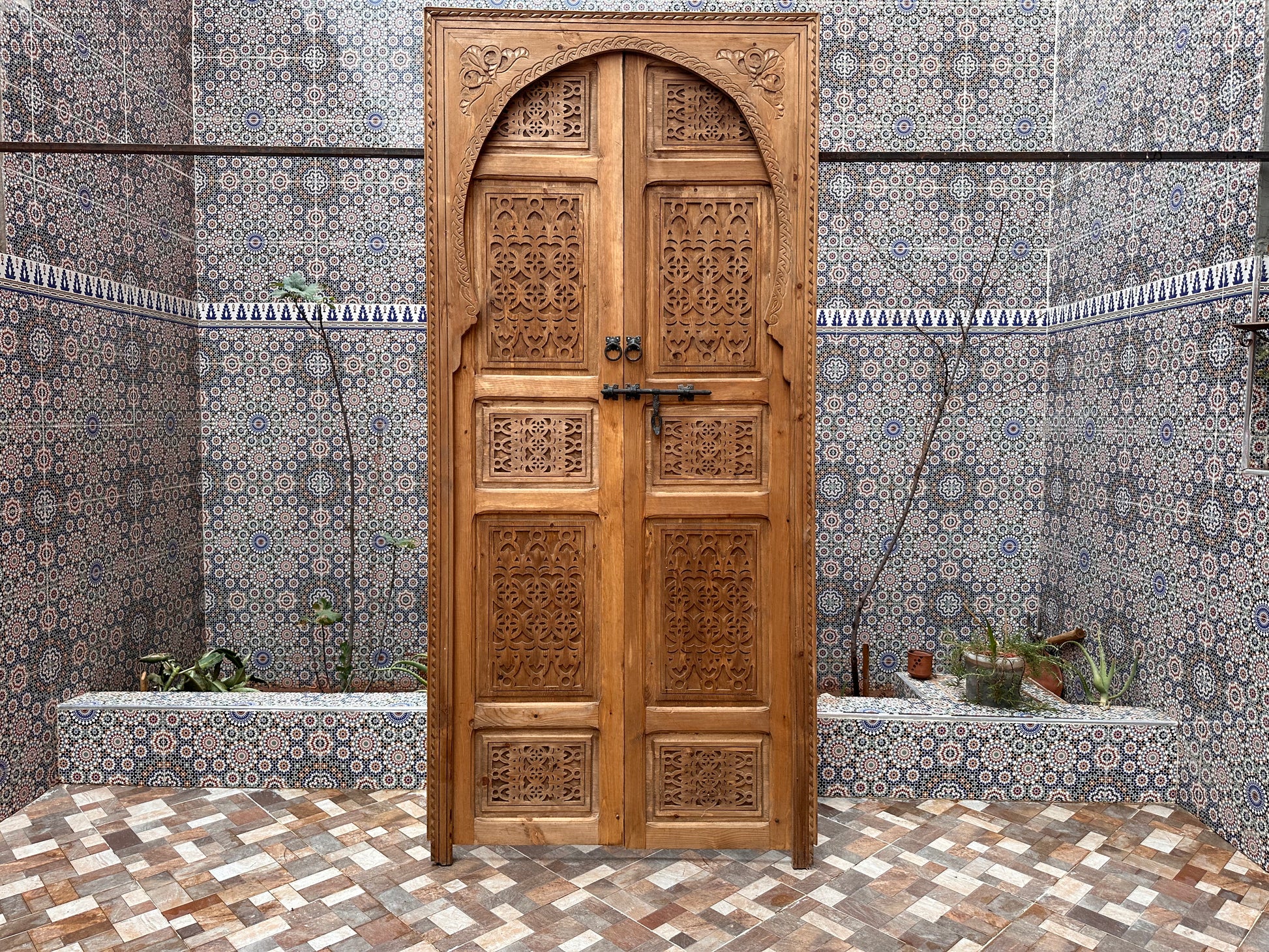 Light wood bedroom door, carved with wavy patterns, creating a calming and serene atmosphere.