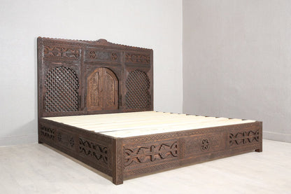A spacious wooden bed frame with a storage drawer.
